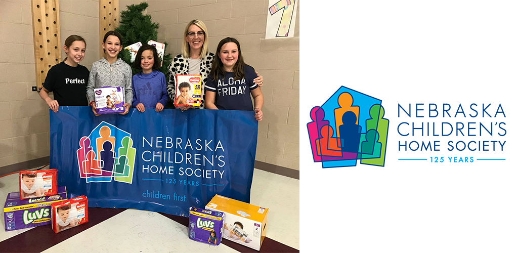 A woman and four girls with their donation of diapers 