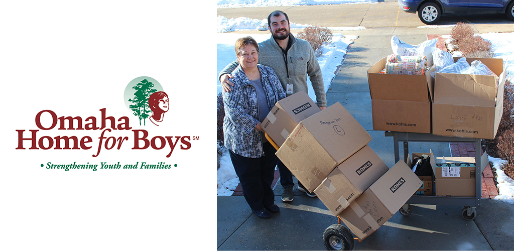 A man and woman standing with their boxes of donated items