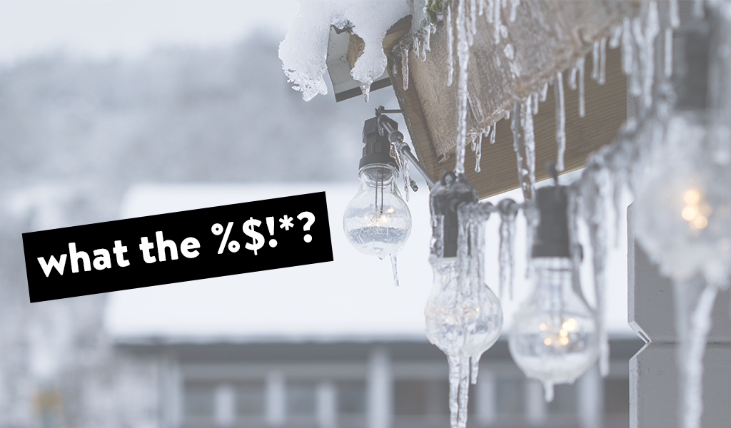 A roof with a string of lights, both with icicles coming down 