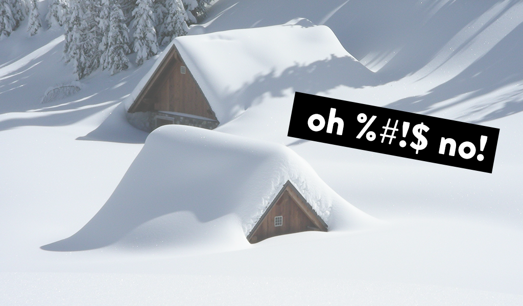 two houses almost completely buried in snow